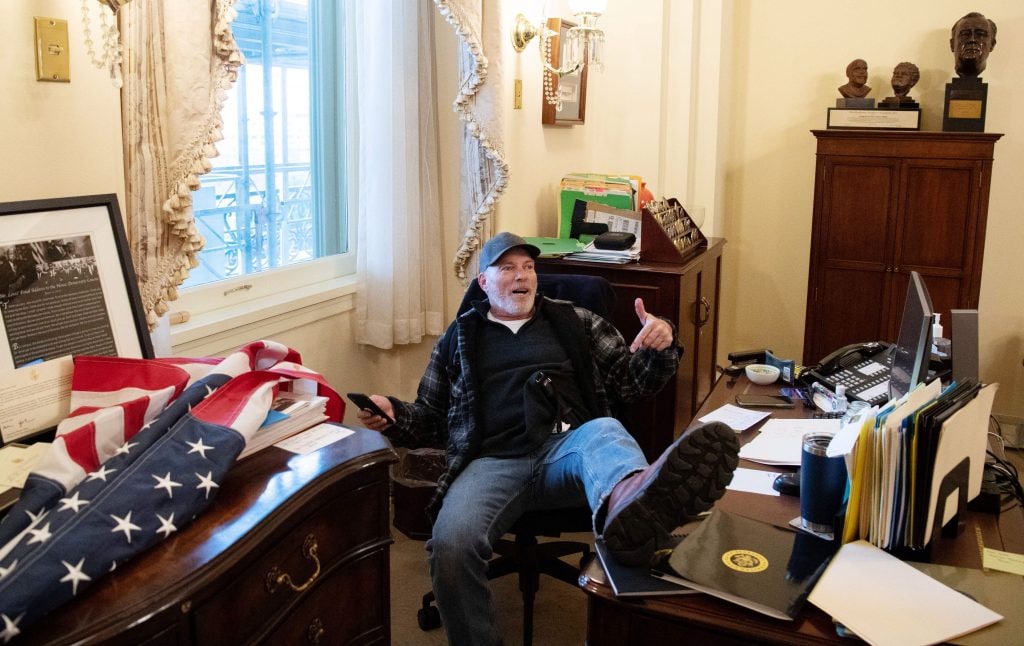 Man who posed at Pelosi’s desk arrested, says he’s ready for violent death