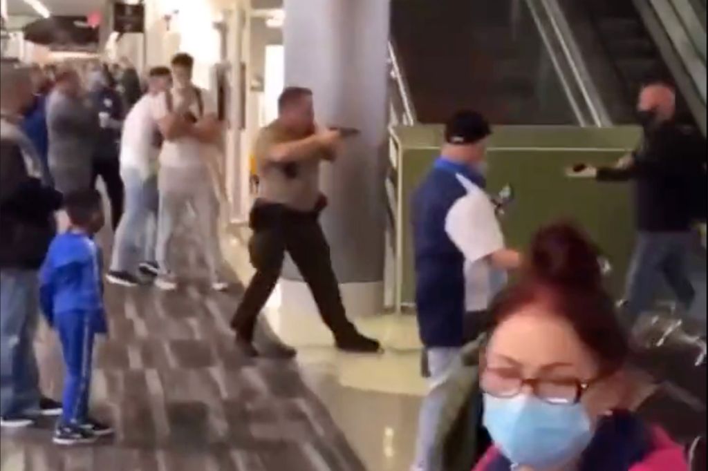 Video Shows Miami Airport Cop Use Violent Chokehold, Pull Out Gun As Delayed Passengers Brawl
