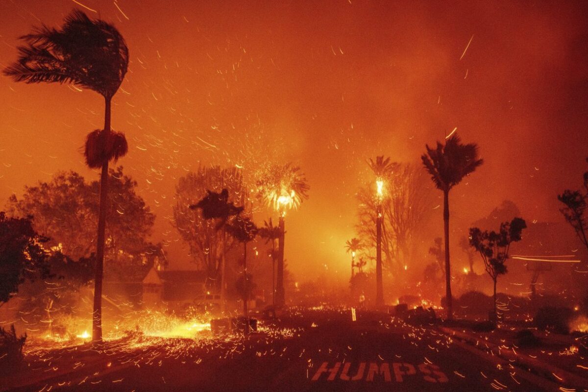 Thousands flee as wildfires burn out of control in and around Los Angeles and homes are destroyed