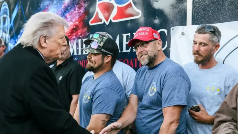 ‘Wow’: Trump’s Photo Op with Blue-Collar Workers Backfires When Fans Zoom In on What They Got for Showing Up Like Extras on Set